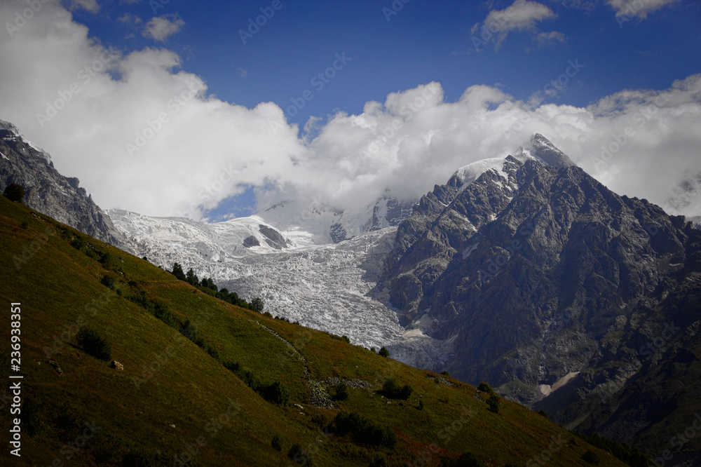 Fototapeta premium Fantastic glacier mountains in the beautiful cumulus