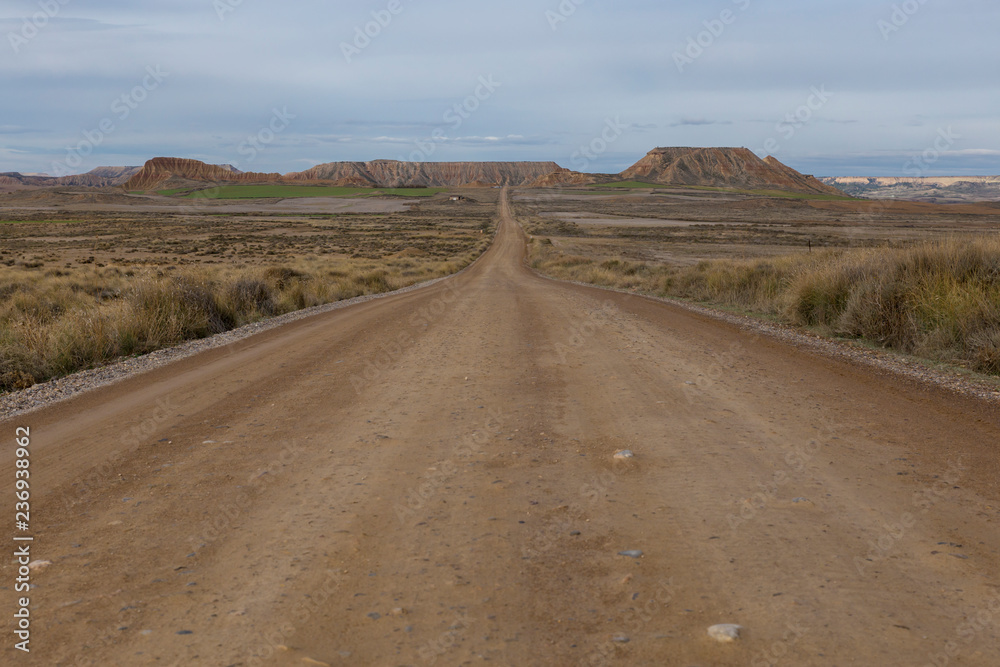 Long lonely road Bardenas Reales natural park, in Navarra, Spain