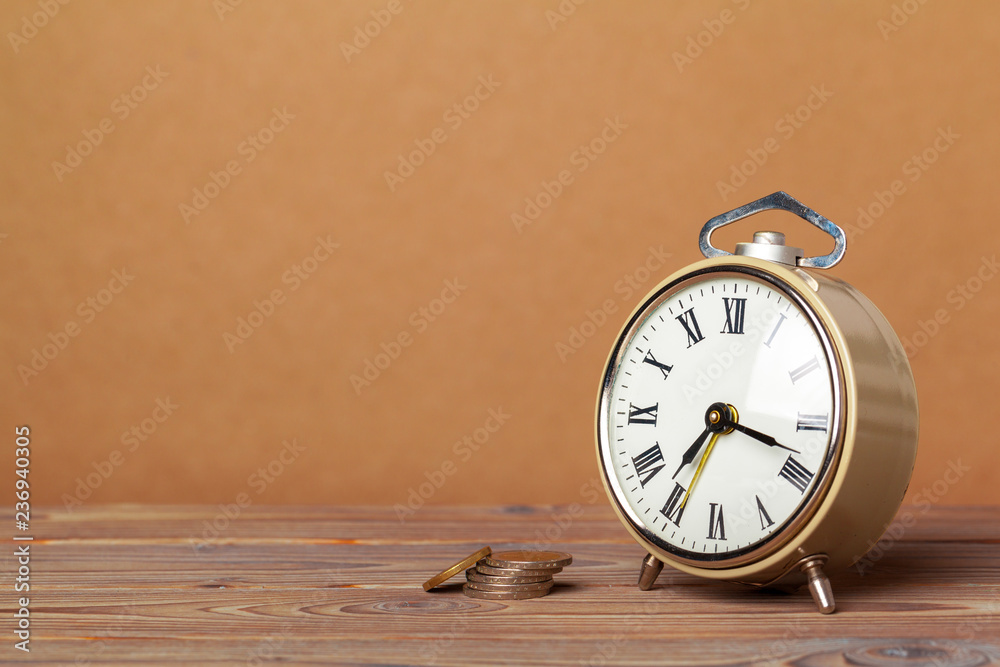 Time is money, table clock with coins Time is money, table clock with coins