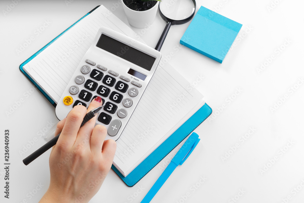 Business woman working with financial data hand using calculator Business woman working with financial data hand using calculator