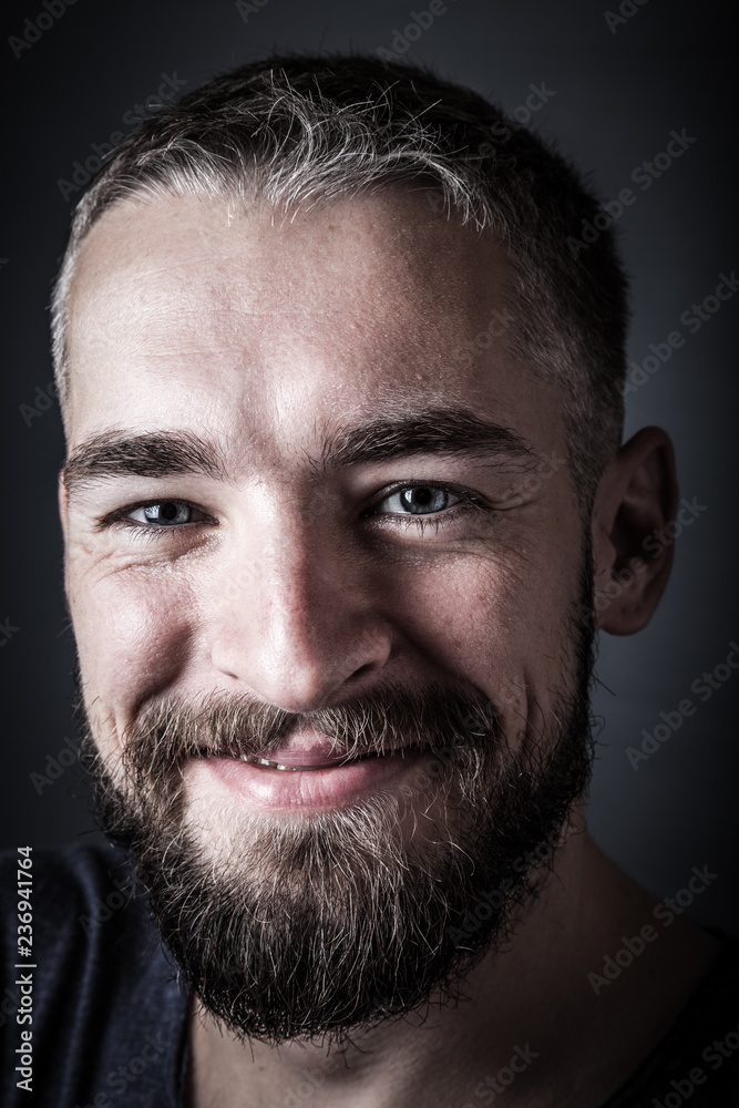 Fototapeta premium Portrait of a young man with a beard. Toned