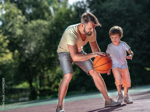 Family playing basketball outdoors
