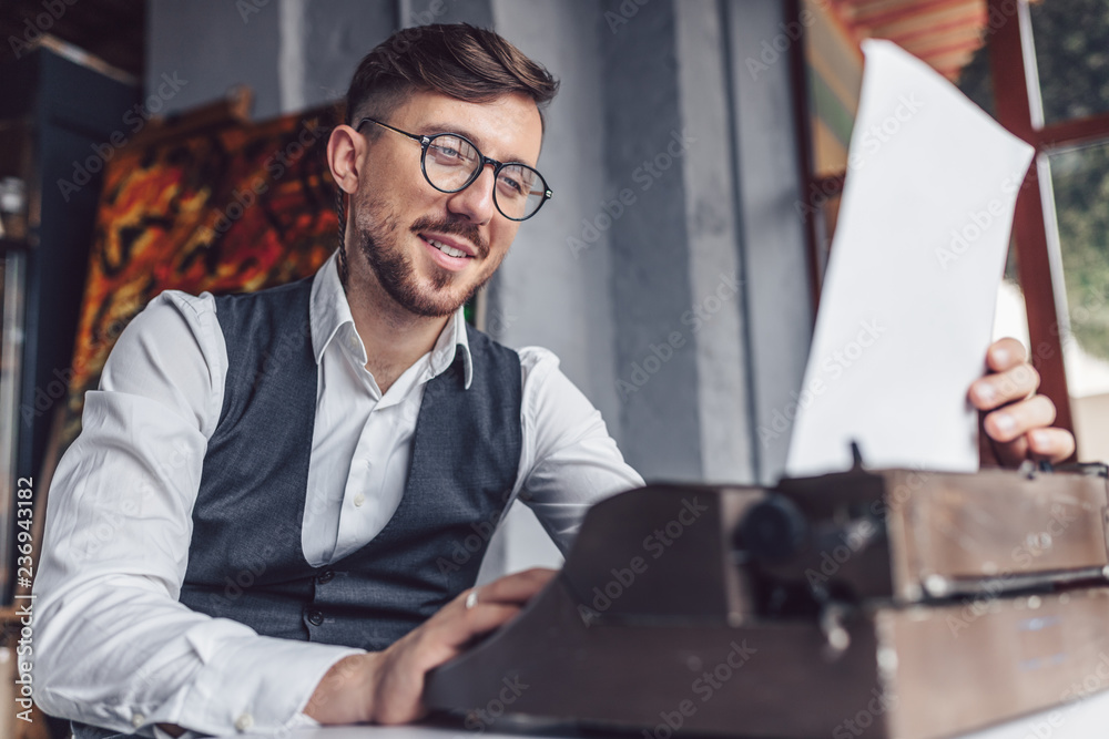Fototapeta premium Smiling man reading the screenplay