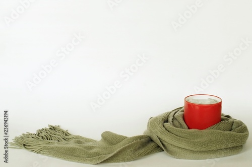 Scarf  wrapped around acup of coid water, like taking care. photo