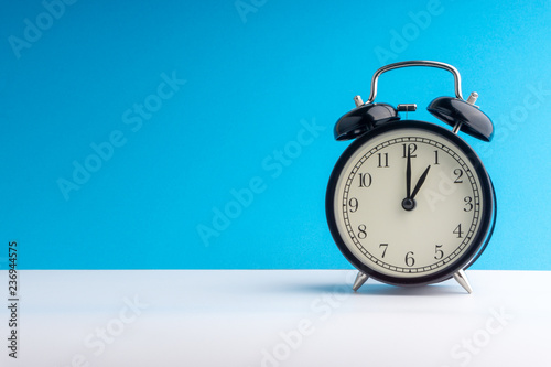 Clock on colorful background with selective focus and crop fragment. Copy space concept