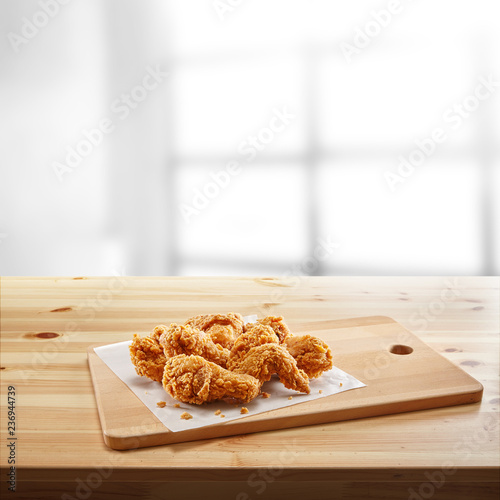 crispy coated batter southern style fried chicken in a wooden table