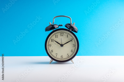 Clock on colorful background with selective focus and crop fragment. Copy space concept