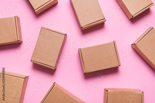Lot of cardboard boxes on pink background photo