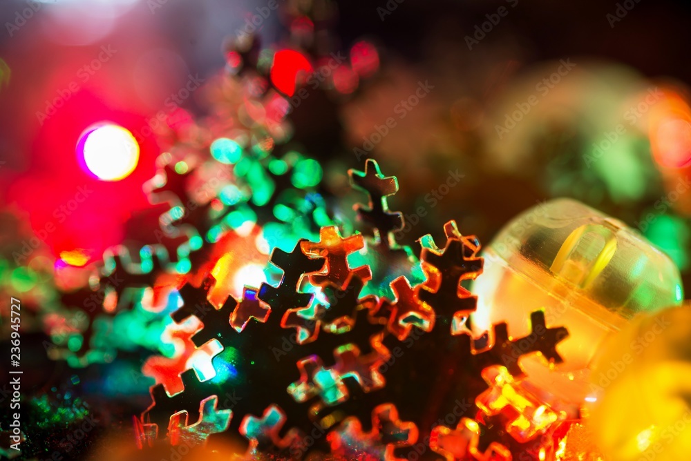 Christmas snowflake on shining colorful bulbs background