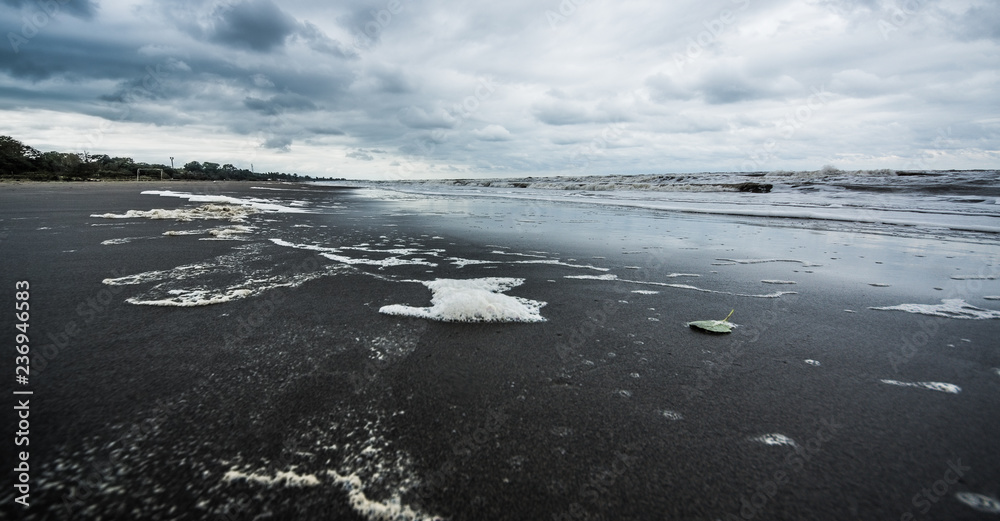 Fototapeta premium Caspian sea under blue sky in early September, snag on the beach