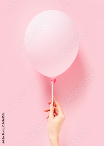 Fotografie Pink pastel baloon on pink background, lightness, easiness concept
