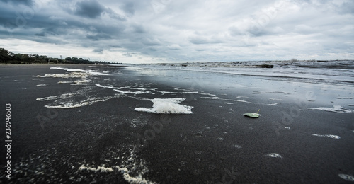Caspian sea under blue sky in early September, snag on the beach