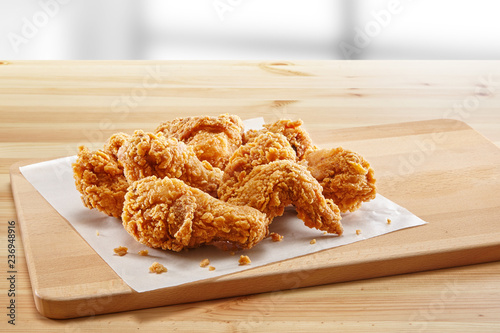 crispy coated batter southern style fried chicken in a wooden table