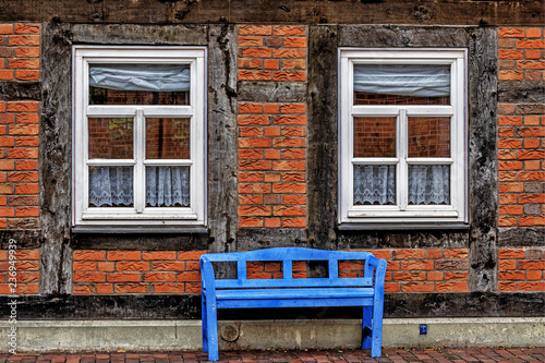 Old half-timbered house and a blue bench in Nienburg photo