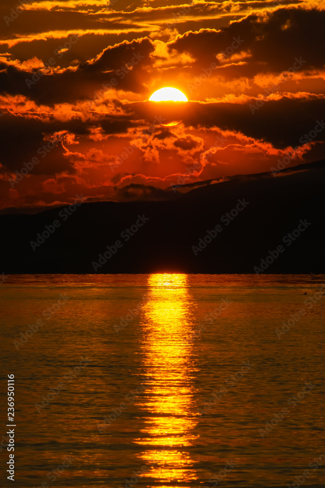 Sunset view over the lake and mountains. Cloudy sky. Iznik, Bursa, Turkey. Sunset view over the lake and mountains. Cloudy sky. Iznik, Bursa, Turkey.