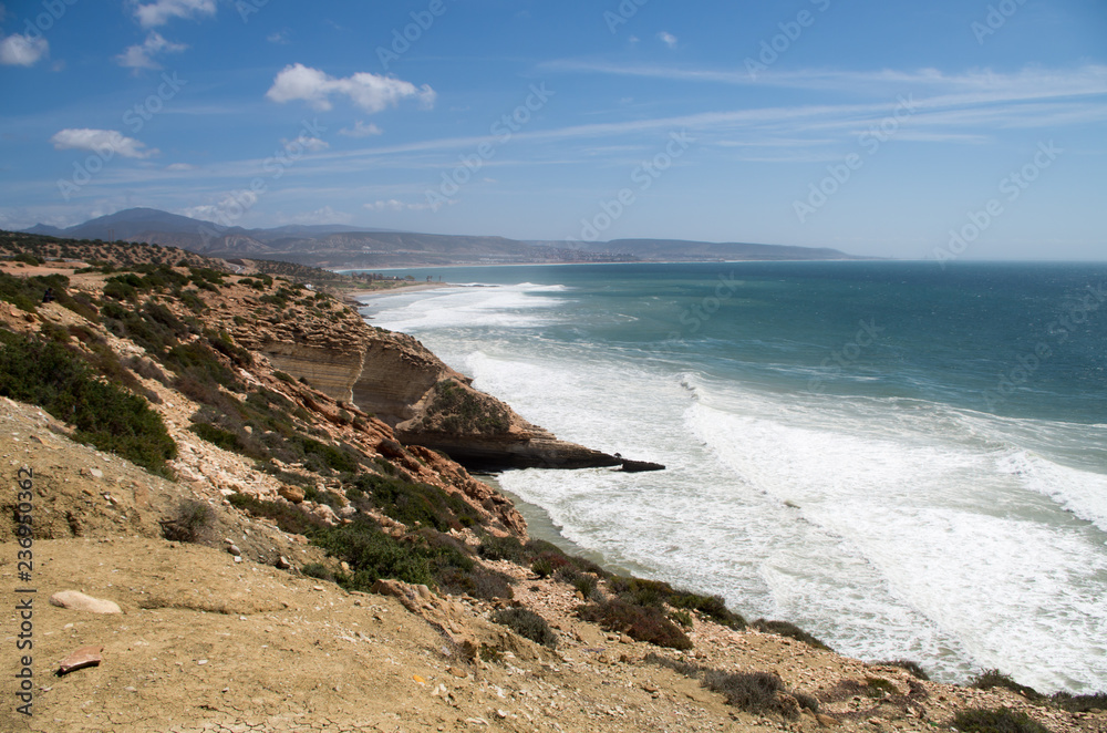 Waves arriving at Killer Point surf spot with view towards Taghazout.