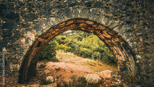 Ancient stone arch canal (Aqueduct) for water transportation. Kaynaklar village, Izmir, Turkey. photo