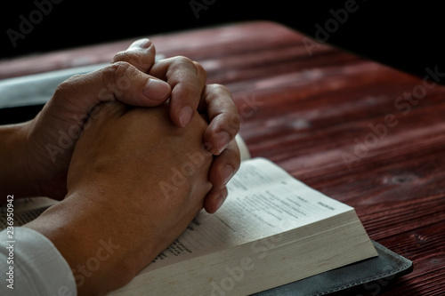 Man Praying to God with His Bible, Prayer with Reading the Bible on the Wood Table