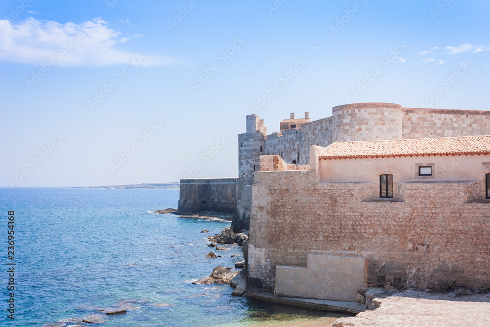 Seacoast near Castello Maniace – ancient castle in Ortygia (Ortigia) Island, Syracuse, Sicily, Italy, traditional architecture