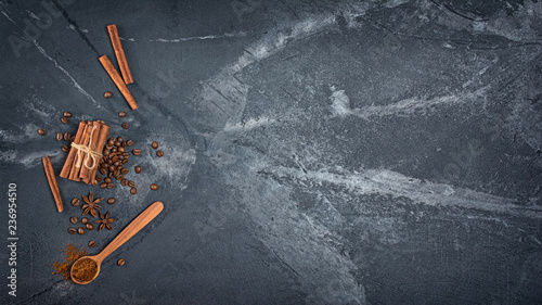 Top view of ingredients for spicy beverage - coffee beans, cinnamon sticks and anise stars