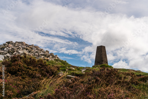 The Two Rock Mountain, Fairy Castle summit on a cloudy day in Dublin, Ireland. Landscape of an Irish mountain peak under a blue sky with white clouds.
