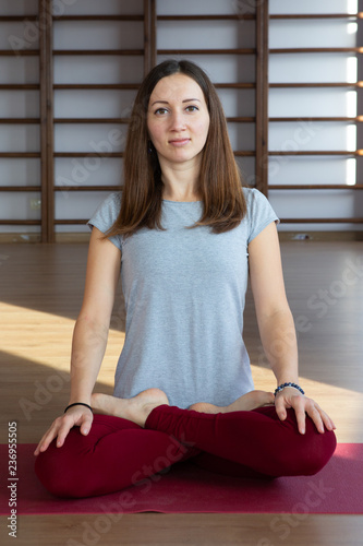 Young woman in the lotus position while meditating