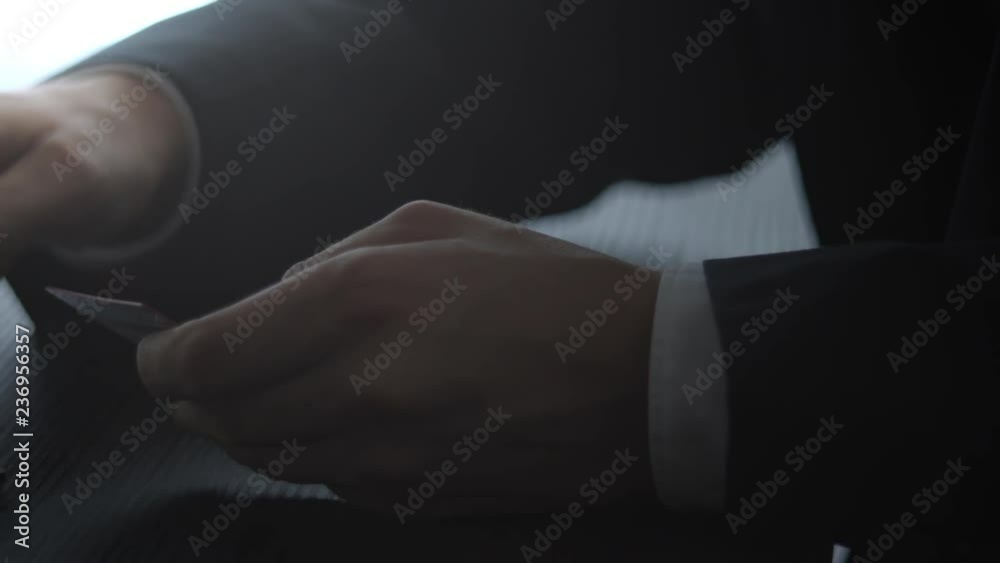 Male hands hold credit card pressing buttons and making online purchase closeup anti-fraud and financial security entering client discount program number filling personal information concept.