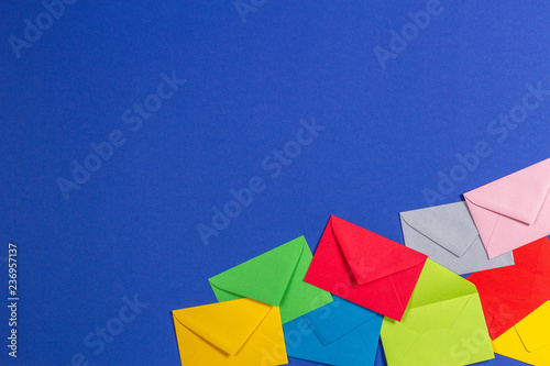 Colorful envelopes on blue background  top view