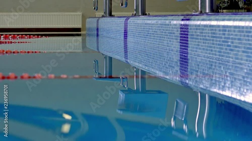 Background waves and reflections in the pool water before the championship. Camera on slider