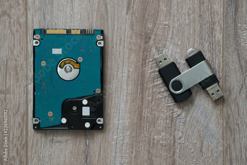 Wallpaper Mural Hard Disk Drive (HDD) and two flash drives on brown wooden background Torontodigital.ca