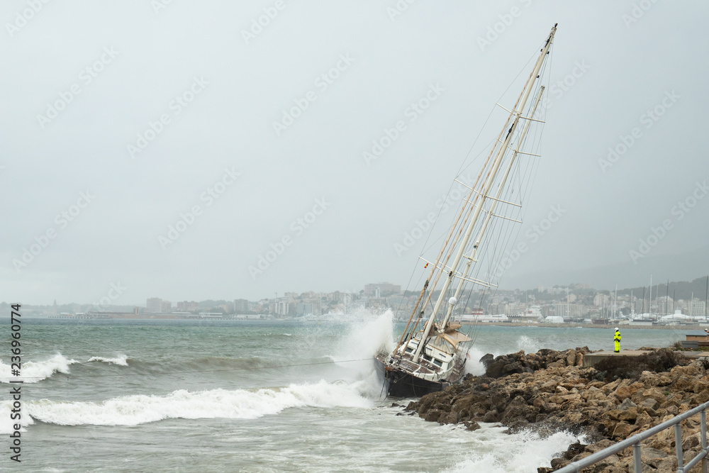 A nautical accident in which the sailboat beats hard on the rocks of the coast in the middle of a storm