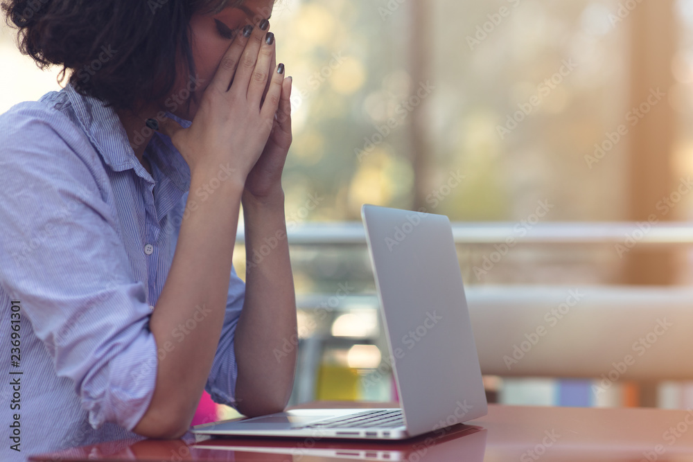 Stressed hipster businesswoman working on laptop in her office Stressed hipster businesswoman working on laptop in her office