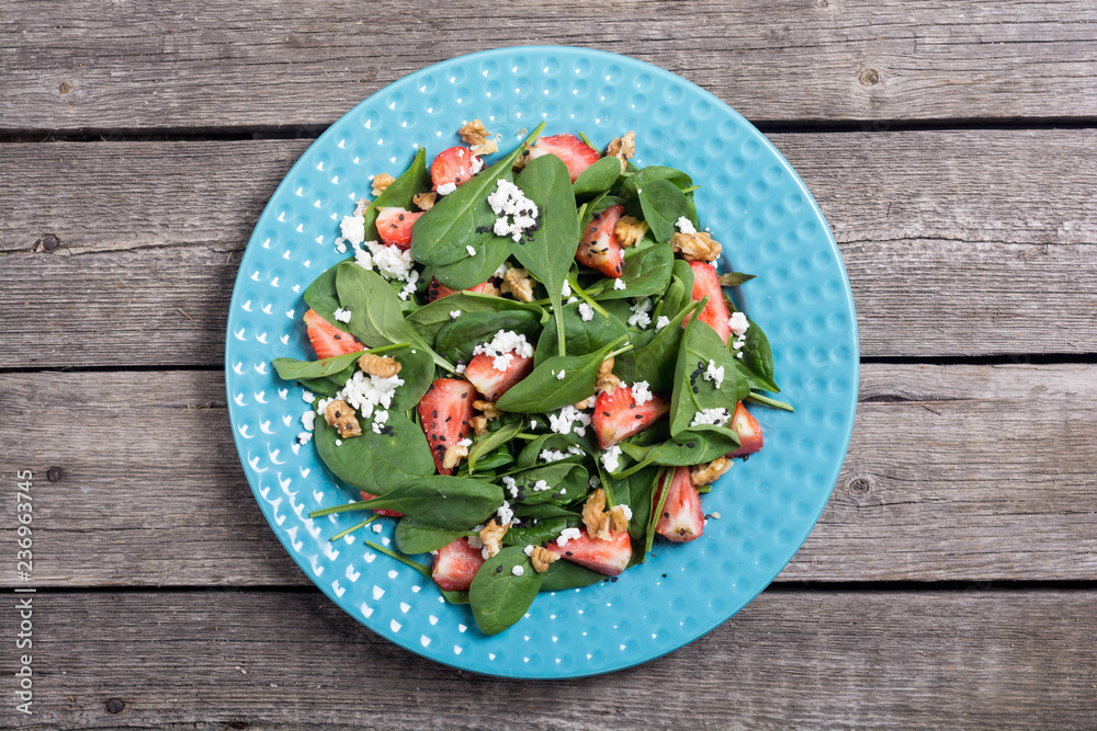 Strawberry salad with spinach , cheese and walnut . Healthy food