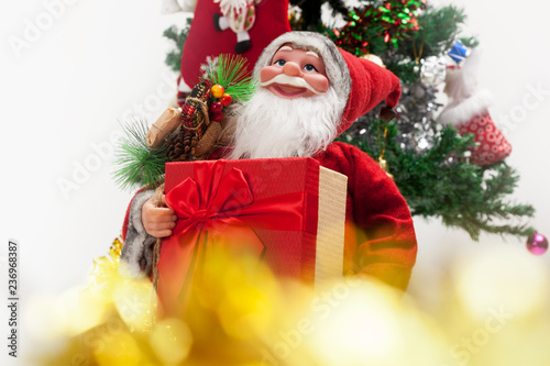 Santa Claus with gift box and bokeh . Christmas and new year concept.