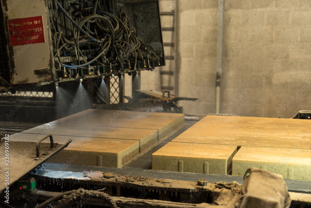 Kampen - The Netherlands - May 11 2017 - Production line where concrete paving tiles are impregnaned with waterresistant substance spraying Kampen - The Netherlands - May 11 2017 - Production line where concrete paving tiles are impregnaned with waterresistant substance spraying