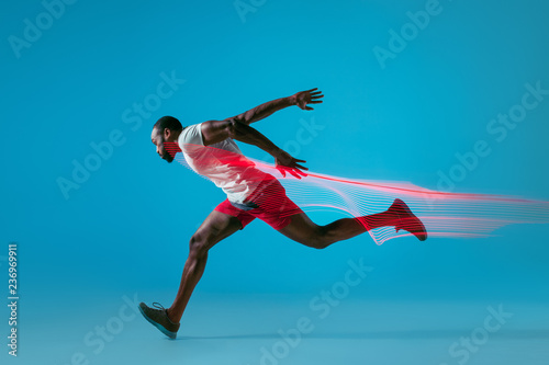 Full length portrait of active young muscular running man, photo