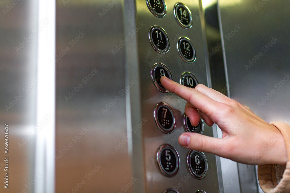 Pressing the button in the elevator. Elevator call Stock Photo Adobe