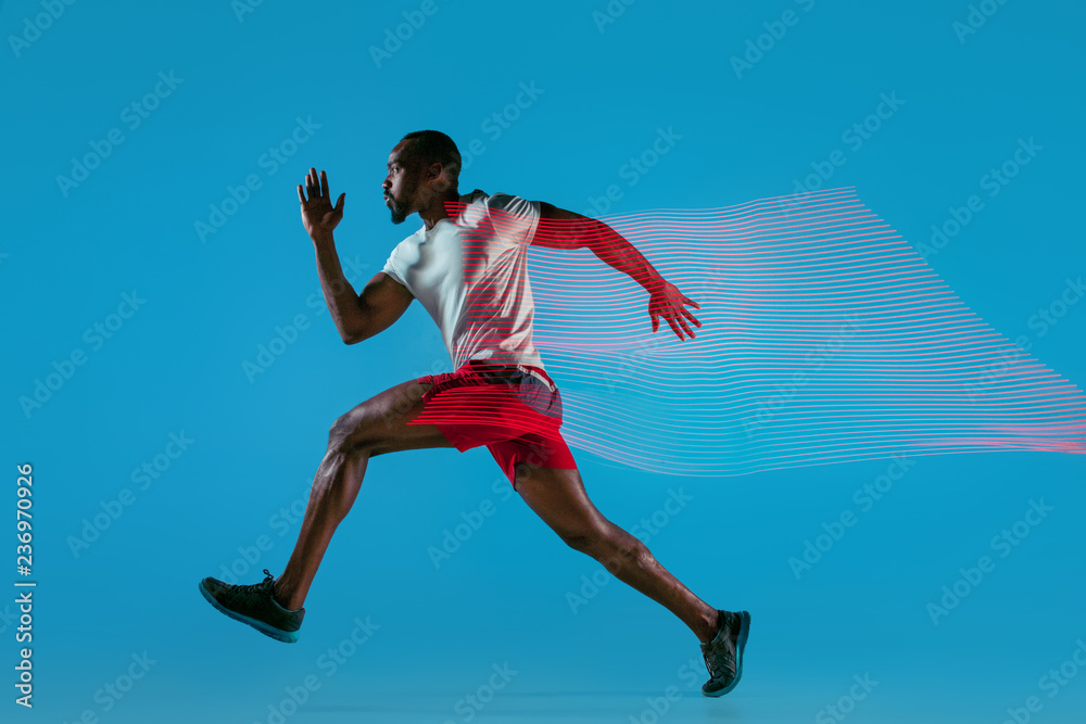 Full length portrait of active young muscular running man,
