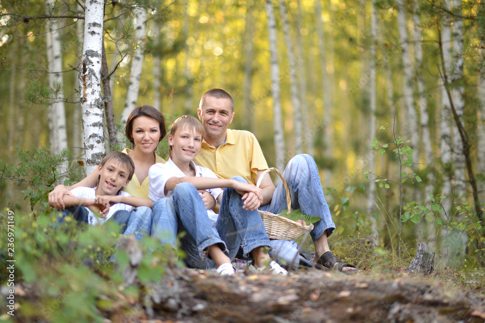 Portrait of happy family of four in autumn park