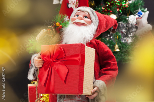 Santa Claus with gift box . Christmas and new year concept, with bokeh.
