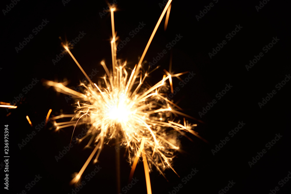 A burning sparkler on a black background isolated A burning sparkler on a black background isolated