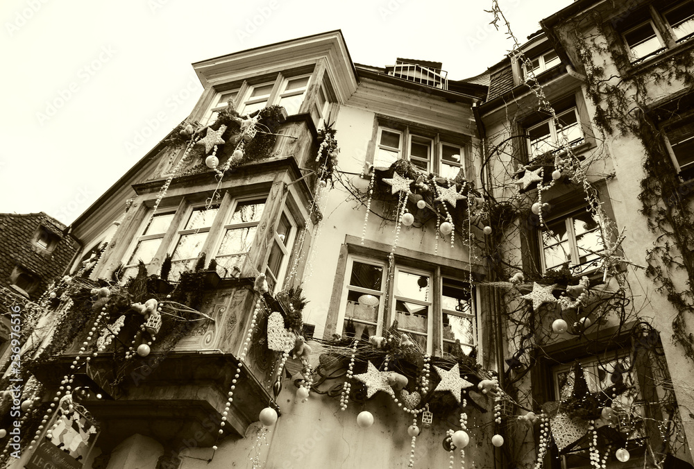 Christmas decoration with white bears, red hearts, stars, and snowflakes in medieval city of Strasbourg (France) which is considered as a Capital of Christmas. Sepia photo.