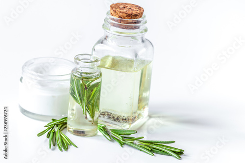 organic cosmetics with extracts of herbs rosemary on white backg