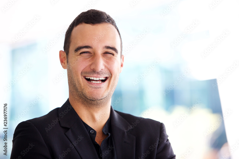 Close up happy businessman laughing Close up happy businessman laughing
