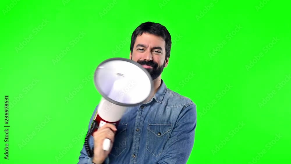 Man on green screen chroma key background holding a megaphone Man on green screen chroma key background holding a megaphone