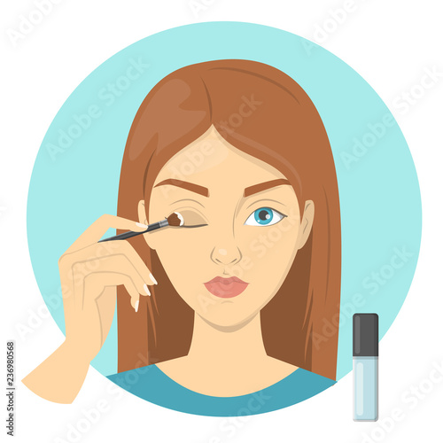 Beautiful woman applying primer for eyeshadow on eyelid