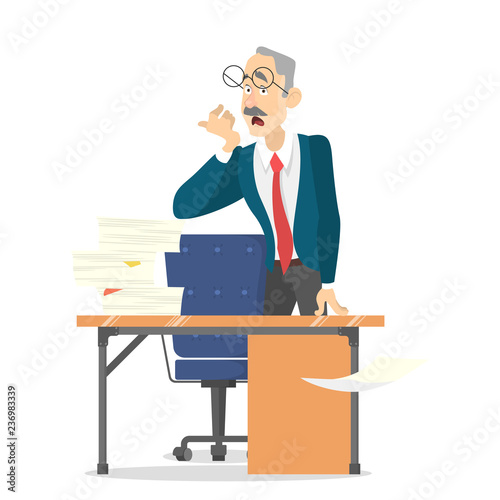 Man at the desk with pile of document on it.