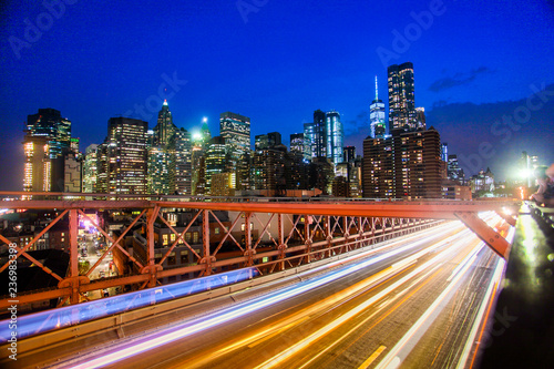 Buildings and transportation on Brooklyn bridge in night New York.