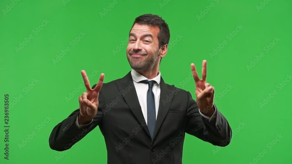 business man smiling and showing victory sign with a cheerful face business man smiling and showing victory sign with a cheerful face