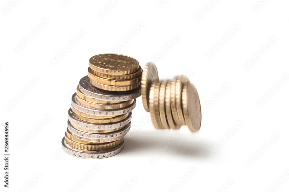 Closeup of euros coins falling on white background - concept crisis Closeup of euros coins falling on white background - concept crisis